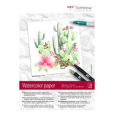 Ett block som det står Watercolor paper på. På framsidan syns kaktusar och blommor som målats.